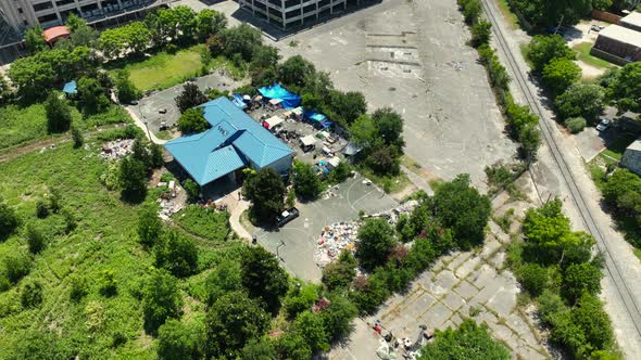 Aerial reveal of an abandoned military facility in New Orleans with the City of New Orleans in the b alt