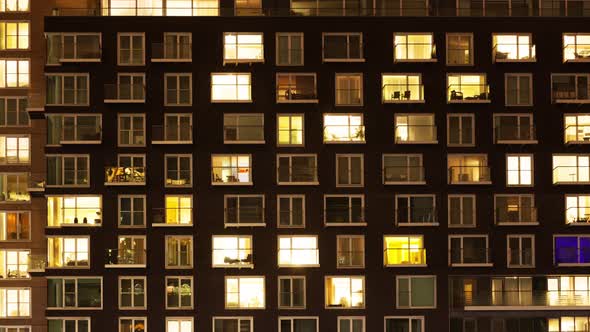 The exterior of a modern apartment block at night