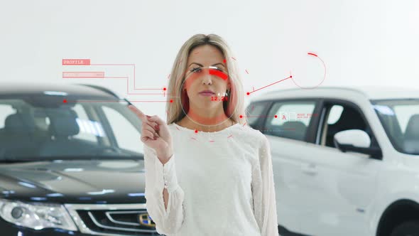 Beautiful Girl Uses the Interface of the Future Against the Backdrop of New Cars
