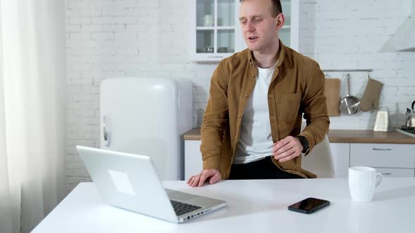 Businessman working on laptop from home office alt