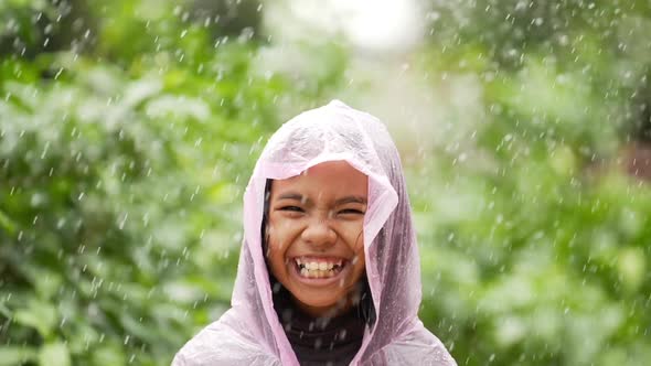 Happy girl wears raincoat alt