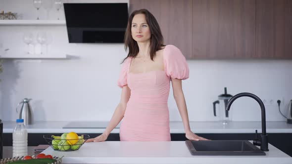 Front View Portrait of Beautiful Caucasian Young Brunette Woman in Pink Fashionable Dress Standing alt