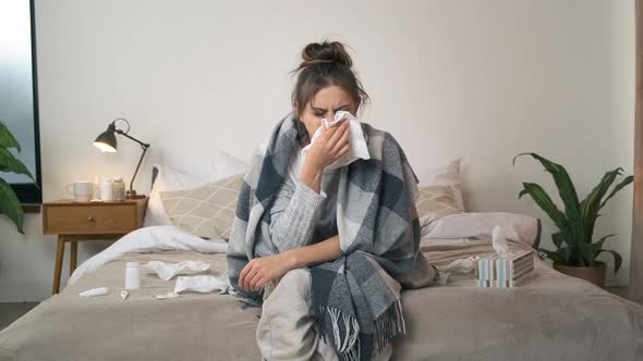 A Sick Woman Wipes Her Nose with a Napkin and Then Gets Mad Because She is Tired of Being Ill at alt