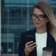Modern Businesswoman working on Smartphone outside, drinking Coffee to go. - VideoHive Item for Sale