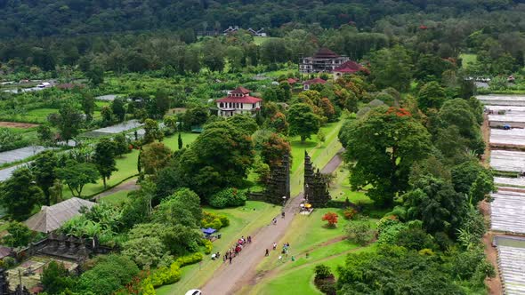 aerial of tourists taking photos at the famous Handara gate in Bali Indonesia during a sunny morning alt