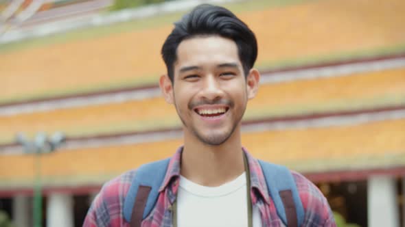 Smiling portrait of handsome young Asian man tourists.