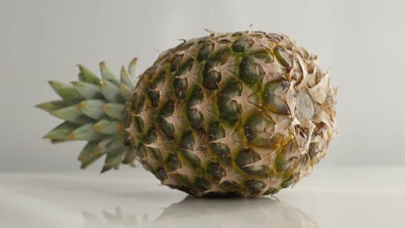 Tropical pineapple fruit close-up  slow tilt 4K 2160p 30fps UltraHD  footage - Whole Ananas comosus 