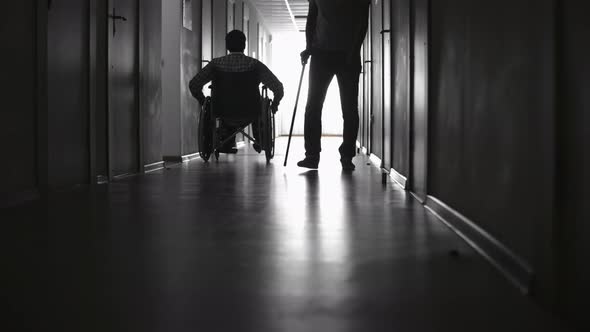 Silhouettes of Disabled Patients in Hospital Corridor alt