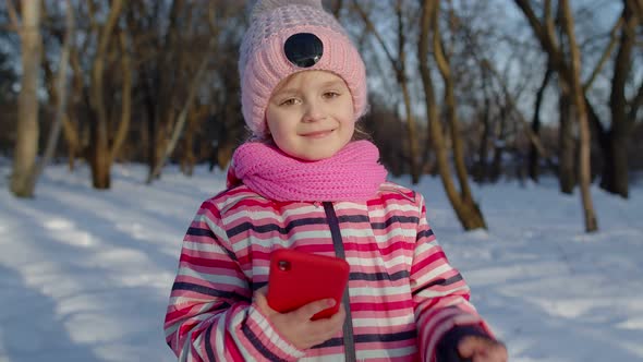 Children Kid Tourist Blogger Browsing on Mobile Phone Publishing New Photo Post on Social Media alt