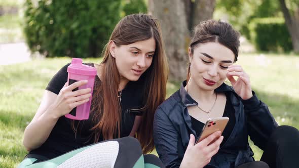 Two Girls Are Relaxing After Training Outdoors alt
