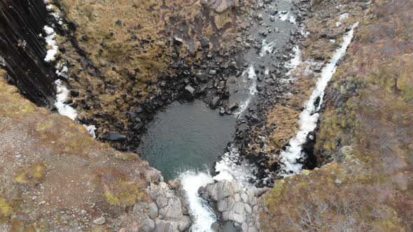 Aerial View, Svarifoss Waterfall, Iceland. Natural Landmark at Autumn, Pull Back Drone Shot alt