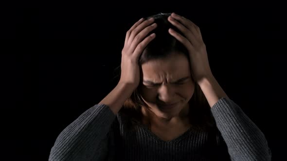 Desperate Teenage African Girl on Dark Background alt
