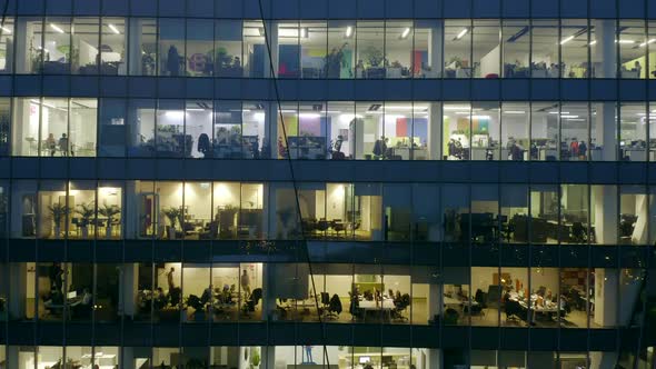 Drone Shot at Office Windows in Modern Skyscrapers at Night alt