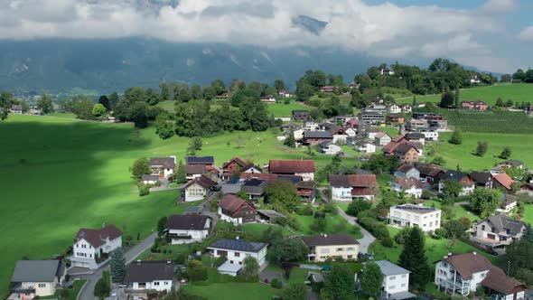 Aerial View of Liechtenstein with Houses on Green Fields in Alps Mountain Valley alt