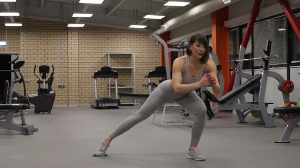 Sporty Woman Warming Up and Training in Gym