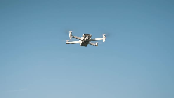 White Drone Hanging in Air or Flying on Nature Background 4K Shot	 alt