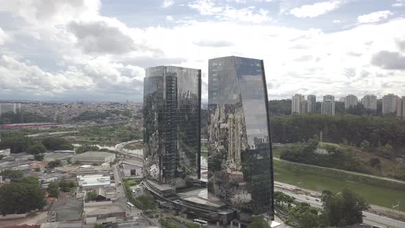 Mirrored two Building and Clouds with cars and river drone 4k