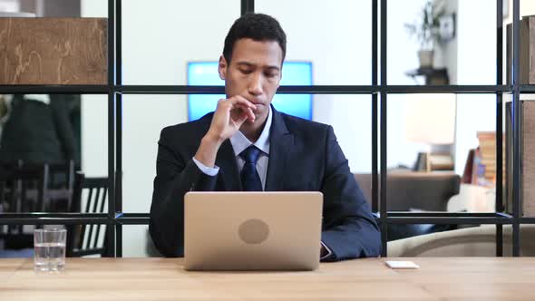 Pensive Businessman Working on Laptop alt
