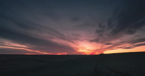 Dark Sky Time Lapse At Sunset Over Empty Field