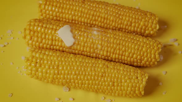 Delicious Boiled Sweet Corn on Yellow Background alt