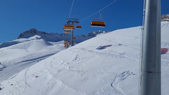 Ski lift in a ski resort in the german alps. Skiers on a ski slope on a sunny winter day.