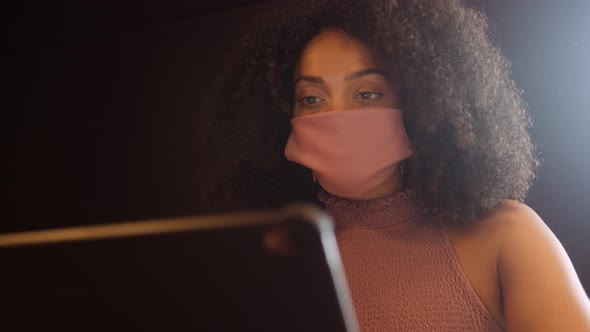 Close Up Of Businesswoman Wearing Face Mask Working On Laptop In Office During Covid-19 Pandemic