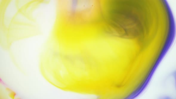 Ink in Water, Yellow and Violet Ink Reacting in Water Creating Abstract Background