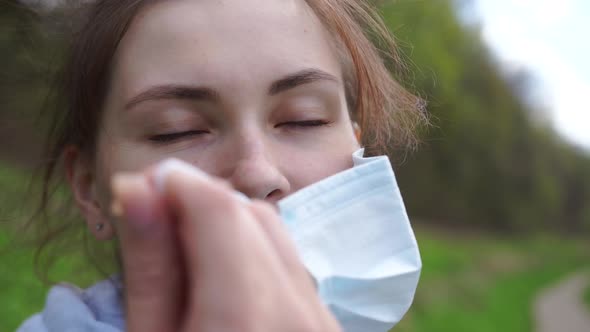 Woman in Park Takes Off Protective Mask From Her Face and Breathes in Air Deeply