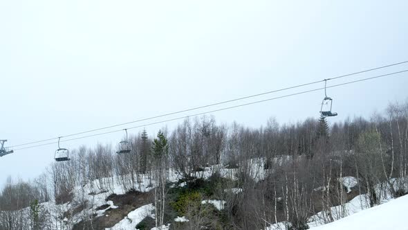 Empty Funicular Cabins Go on the Ropeway Through Fog. Timelapse Footage. Early Morning Trip Above alt