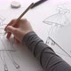 The designer draws sketches of women&#39;s clothing. The artist creates the design of dresses on paper. - VideoHive Item for Sale