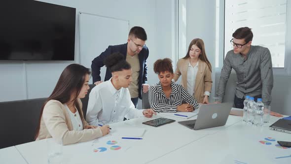 Black Man Presenting New Project at Business Meeting alt