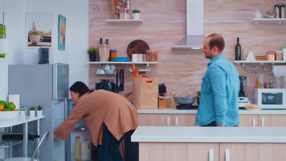 Wife Taking Bell Peppers From Refrigerator alt