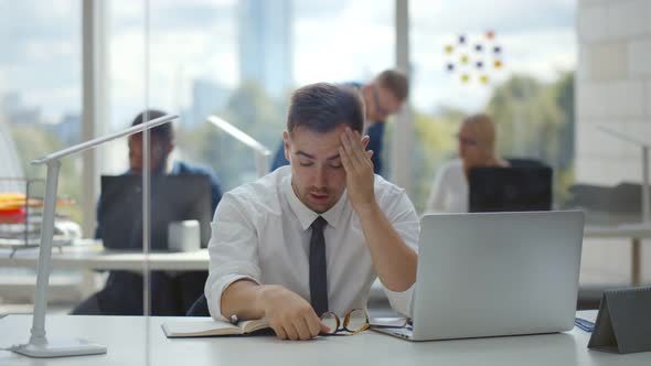 Tired Young Businessman Feeling Stressed and Taking Off Eyeglasses Having Eye Strain alt