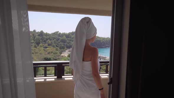 A Beautiful Slender Woman Overlooks the Balcony of an Elite Hotel alt