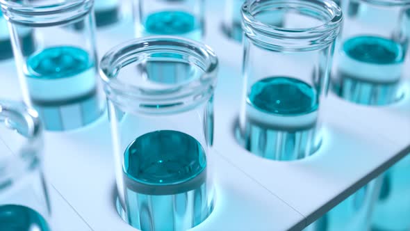 Loopable animation of test tubes filled with cyan blue liquid. Side view. 4KHD alt