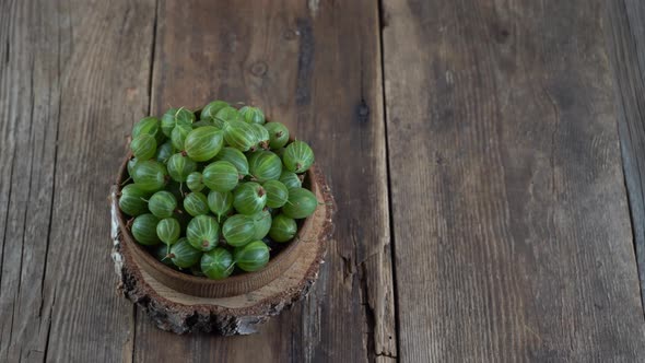 Green Gooseberries in a Wooden Bowl alt