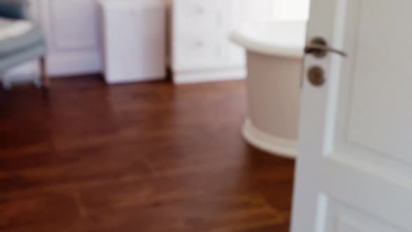 Son covering his eyes while watching television with father alt