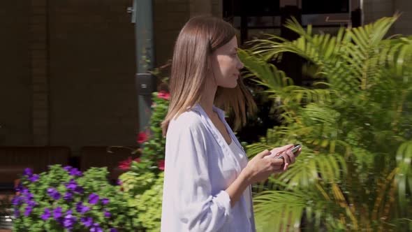 Attractive young woman walking at the city park.