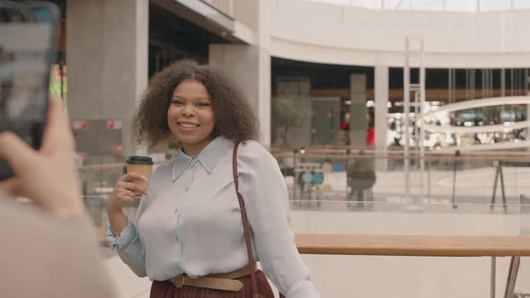Young Curvy Black Woman Posing for Camera with Shopping Bags alt