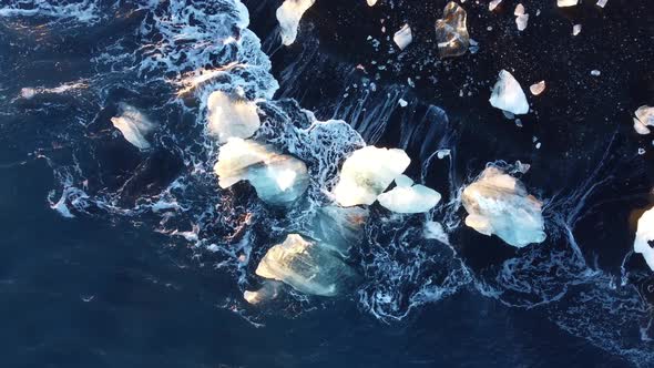 Waves Crashing Over Ice Formation Diamond Beach of the Breidamerkursandur Glacial Plain By alt