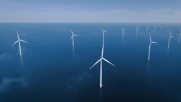 Offshore Windmill Park with Clouds and a Blue Sky Windmill Park in the Ocean Drone Aerial View with alt