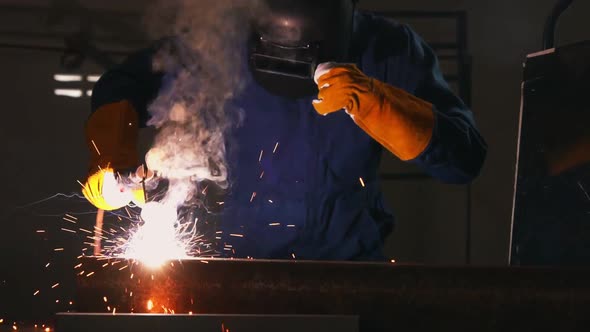 Metal Welder Working with Arc Welding Machine alt