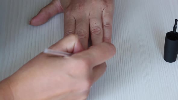 A Woman Applies Nail Polish. She Gives Herself A Manicure.