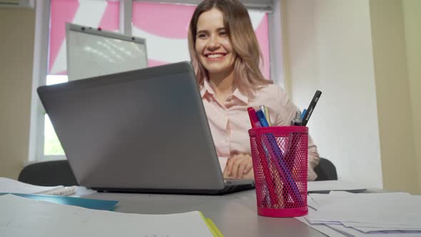 Lovely Female Student Video Calling Someone, Using Her Laptop alt