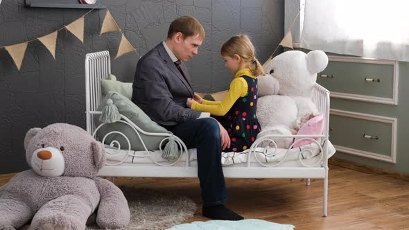 Little Girl Straighten a Jacket of Her Father alt