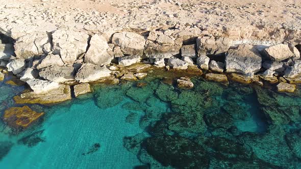 Aerial Landscape at the Edge of the Earth Turquoise Calm Sea Waves Beat Against a Rocky Cliff Ocean alt