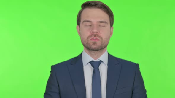 Disappointed Young Businessman Reacting Loss on Green Background alt