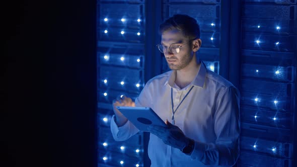 IT Technician in Data Center Digital Server Room Controlling Work of Rack Server Cabinets with a alt