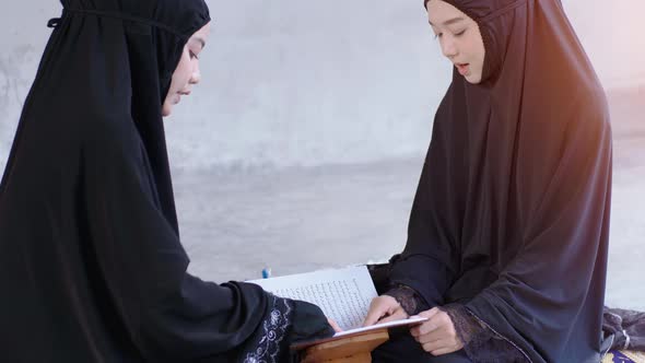 Portrait of an Asian muslim women in a daily prayer at home reciting Surah al-Fatiha passage of the alt