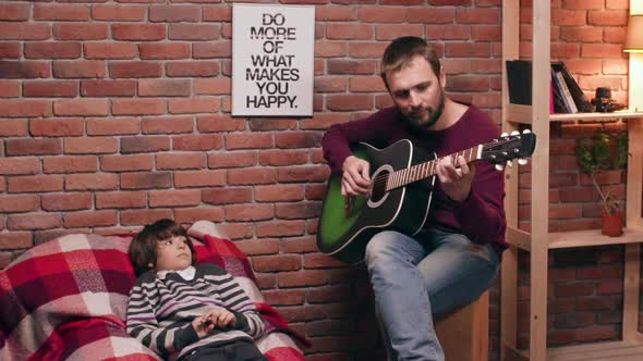 Father Playing Guitar with His Son